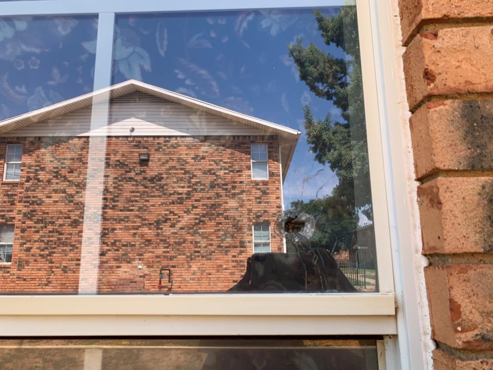 Bullet damage was visible in a window of an apartment unit at Ella Apartments Thursday in Central Lubbock.