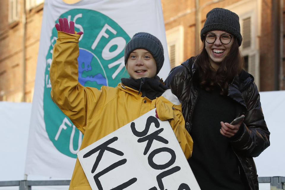 Swedish environmental activist Greta Thunberg holds a sign with writing reading in Swedish "School strike for the climate" as she attends a climate march, in Turin, Italy, Friday. Dec. 13, 2019. Thunberg was named this week Time's Person of the Year, despite becoming the figurehead of a global youth movement pressing governments for faster action on climate change. in Turin, Italy, Friday, Dec. 13, 2019. (AP Photo/Antonio Calanni)