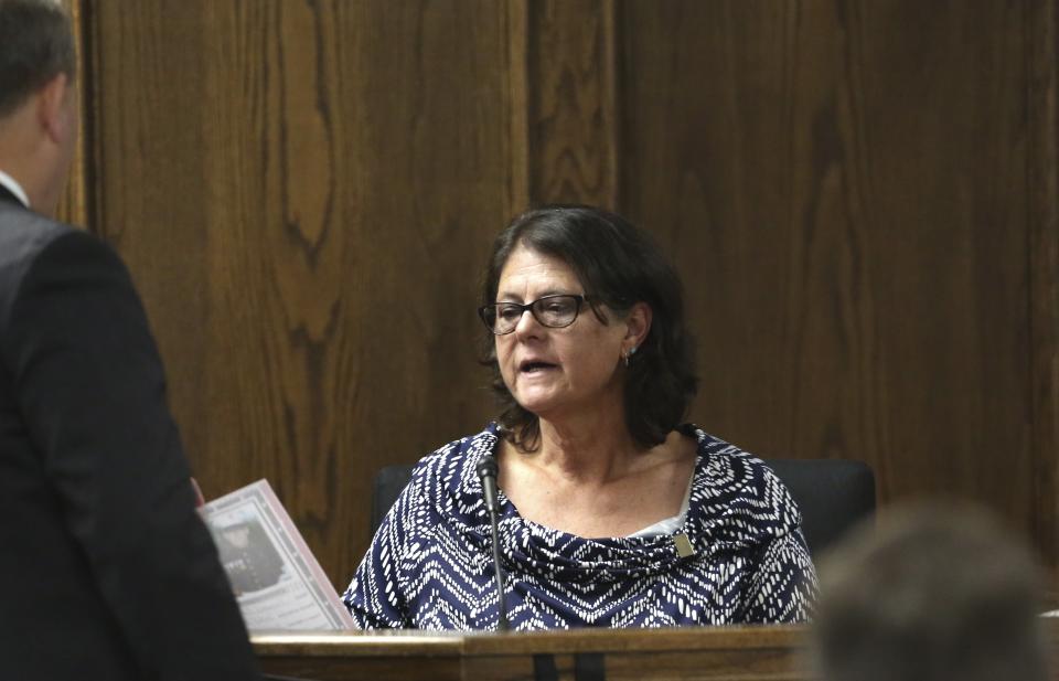 Jodi Routh, right, mother of former Marine Cpl. Eddie Ray Routh, speaks as she looks at a photo of her son that was admitted into evidence during his capital murder trial at the Erath County, Donald R. Jones Justice Center Thursday, Feb. 19, 2015, in Stephenville, Texas.  Routh is charged with the 2013 deaths of former Navy SEAL Chris Kyle and his friend Chad Littlefield at a shooting range near Glen Rose, Texas. (AP Photo/LM Otero,Pool)