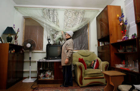 A woman displays her room in a residential house in Donetsk, Ukraine, October 25, 2017. REUTERS/Alexander Ermochenko