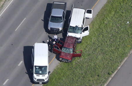 Law enforcement personnel investigate the scene where the Texas bombing suspect blew himself up on the side of a highway north of Austin in Round Rock, Texas, U.S., March 21, 2018. REUTERS/Loren Elliott