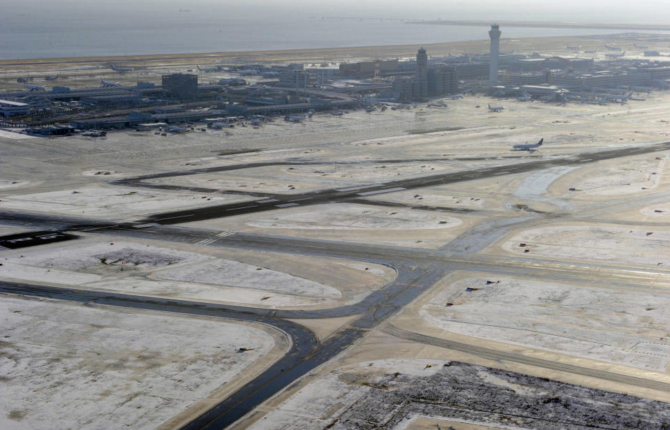 Haneda airport is still covered with snow in Tokyo Tuesday, Jan. 15, 2013 following Monday's snowfall. In the season's first snowfall in the Japanese capital, about 8 centimeters (3 inches) of snow fell in central Tokyo and around Narita on Monday - a national holiday in Japan. The snow snarled traffic and caused train delays. (AP Photo/Kyodo News) JAPAN OUT, MANDATORY CREDIT, NO LICENSING IN CHINA, HONG KONG, JAPAN, SOUTH KOREA AND FRANCE