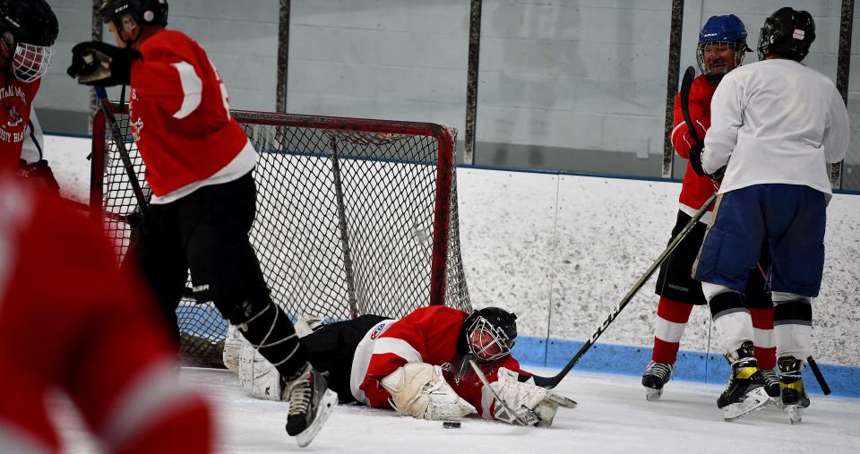 Goalie Mark Pruneau of Sterling jumps in front of the puck for a save during Central Mass Rusty Blades practice.