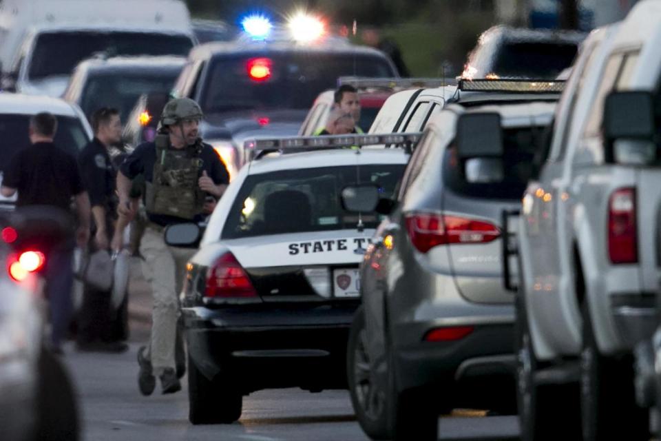 Emergency: Police run on Brodie Lane in Austin after the blast at a Goodwill shop (AP)