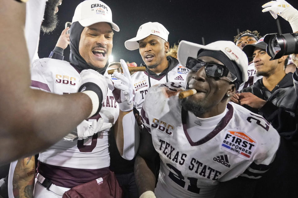 Texas State running back Ismail Mahdi (21) celebrates with teammates after their 45-21 win over Rice in the First Responder Bowl NCAA college football game Tuesday, Dec. 26, 2023, in Dallas. (AP Photo/LM Otero)