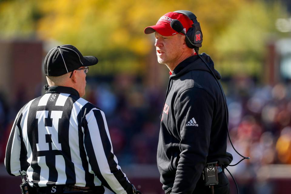 Nebraska head coach Scott Frost speaks with an official during the an NCAA college football game against Minnesota, Saturday, Oct. 16, 2021, in Minneapolis. Minnesota won 30-23. (AP Photo/Bruce Kluckhohn)