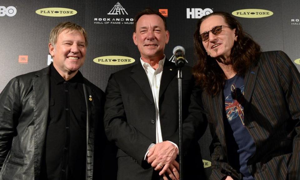 Alex Lifeson, Neil Peart, and Geddy Lee pose in the press room at the 28th Annual Rock and Roll Hall of Fame Induction Ceremony in Los Angeles.