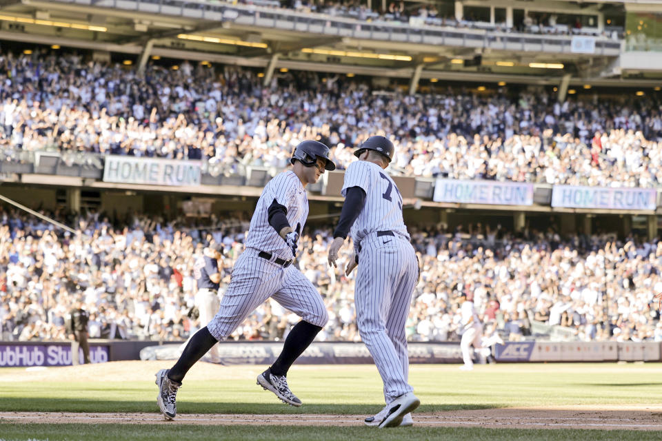 New York Yankees' Anthony Rizzo celebrates his home run with Yankees first base coach Travis Chapman (75) during the seventh inning of a baseball game against Boston Red Sox, Saturday, Sept. 24, 2022, in New York. (AP Photo/Jessie Alcheh)