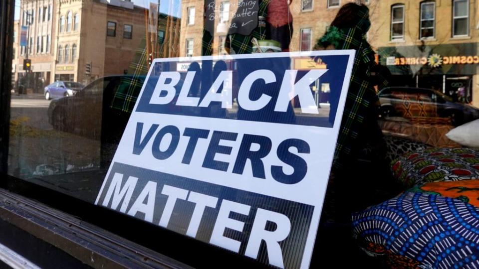 A sign encouraging Black people to vote sits in the window of a downtown storefront Sunday in Racine, Wisconsin. Experts say Russian disinformation campaigns are again targeting Blacks and Latino voters, and they may be working. (Photo by Scott Olson/Getty Images)