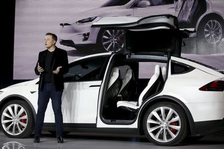 Tesla Motors CEO Elon Musk introduces the falcon wing door on the Model X electric sports-utility vehicles during a presentation in Fremont, California September 29, 2015. REUTERS/Stephen Lam