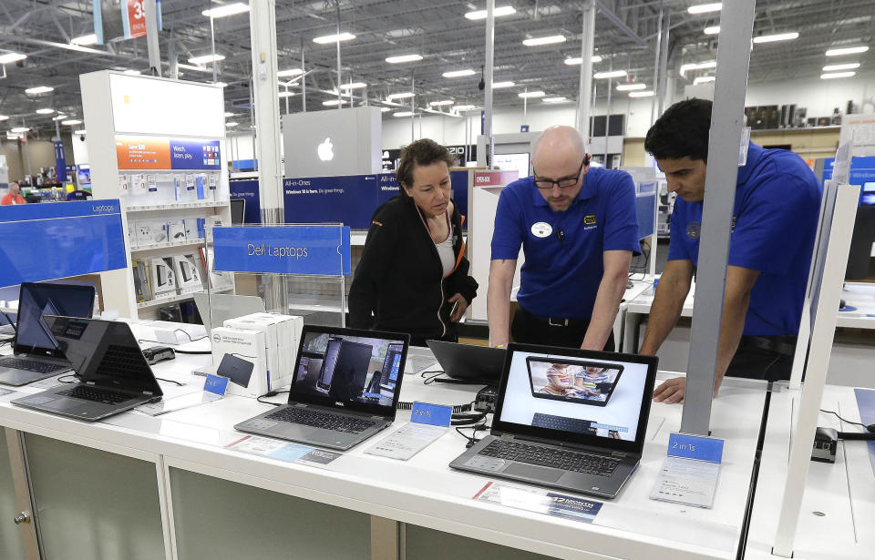 In this Tuesday, May 23, 2017, photo, employees assist a customer with a computer at Best Buy in Cary, N.C. On Wednesday, Sept. 6, 2017, the Institute for Supply Management reports on the August performance of U.S. services firms. (AP Photo/Gerry Broome)