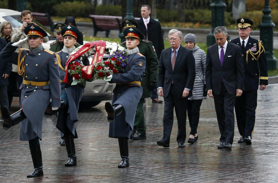 U.S. National Security Adviser John Bolton, fourth from right, walks with U.S. Ambassador to Russia Jon Huntsman, second from right, as they arrive for a wreath laying ceremony at the Tomb of the Unknown Soldier by the Kremlin wall in Moscow, Russia, Tuesday, Oct. 23, 2018. U.S. President Donald Trump's national security adviser Bolton struck a conciliatory note Tuesday in talks in Moscow, just days after Trump vowed to pull out of a key arms control treaty with Russia. (Sergei Karpukhin/Pool Photo via AP)