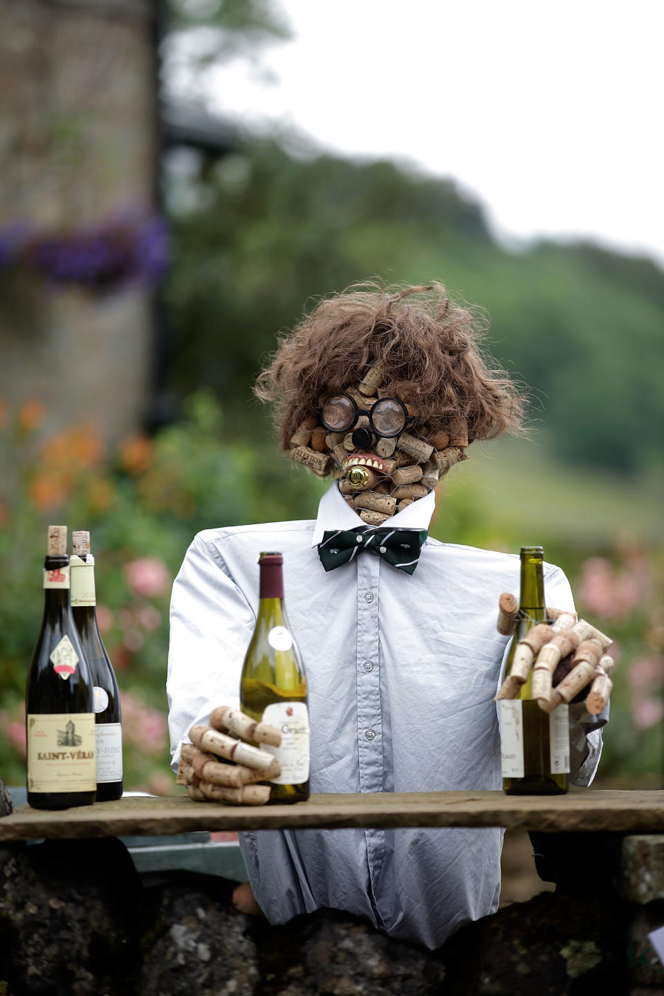 A scarecrow made from corks and dressed as a bartender stands as part of the annual scarecrow festival on August 13.