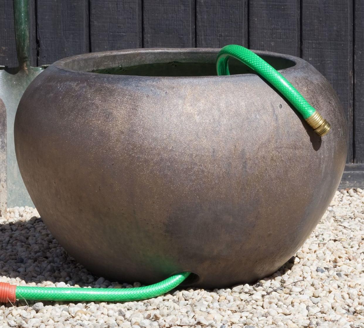 a large pot with a green handle