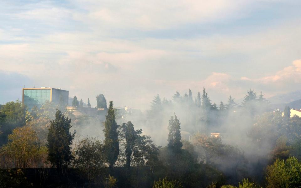 Smoke rises over the Montenegro capital Podgorica, on Sunday, July 16, 2017. - Credit:  Risto Bozovic/AP