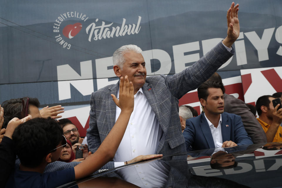 In this Friday, June 21, 2019 file photo, Binali Yildirim, mayoral candidate for Istanbul from Turkey's ruling Justice and Development Party, AKP, salutes supporters following a rally in Istanbul, ahead of the June 23 re-run of mayoral elections. Voters in Istanbul return to the polls on Sunday for a rerun of the election for the mayor of the city. (AP Photo/Lefteris Pitarakis)