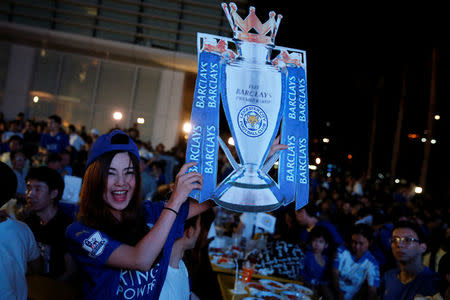 Leicester City fans celebrate after their team drew against Manchester United while watching the game on a big screen, in Bangkok, Thailand, May 1, 2016. REUTERS/Jorge Silva