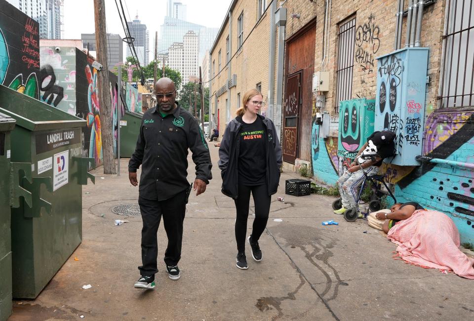Urban Alchemy's Kevin Lee and Sarah Finley, director of the ARCH, walk in the nearby alley where the fatal overdose occurred. People experiencing homelessness weren't the only ones who overdosed.