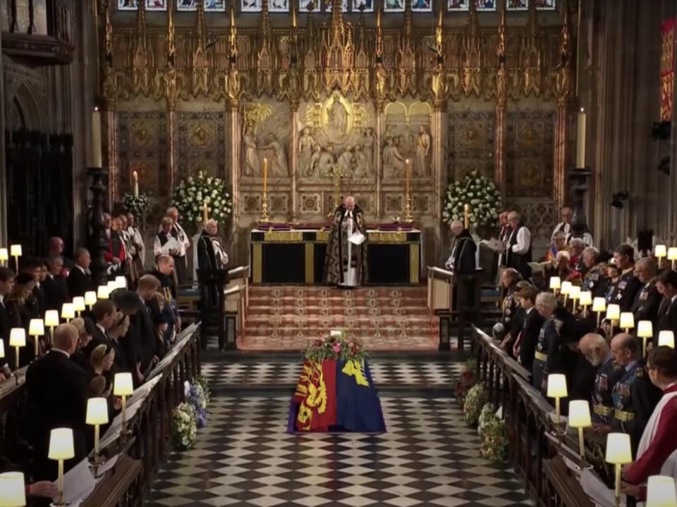 The Queen's coffin begins to be lowered into the Royal Vault at St. George's Chapel in Windsor.