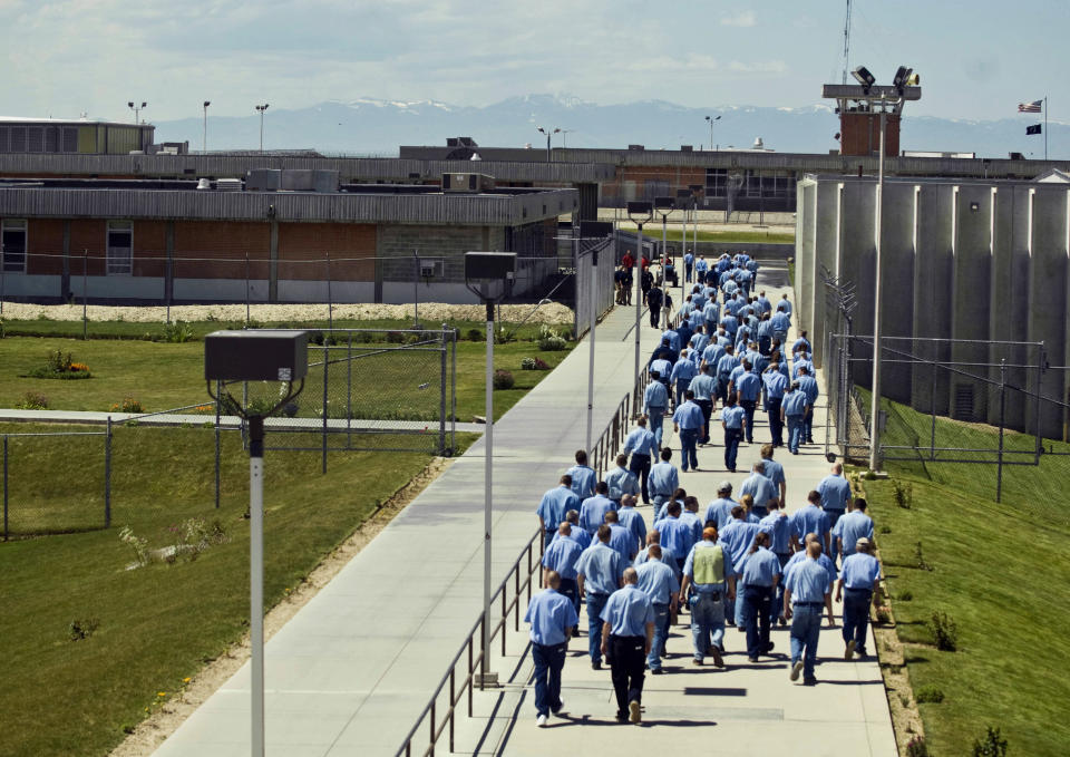 FILE - In this June 15, 2010 file photo, inmates walk to the dinning hall from their cell block at the Idaho State Correctional Institution outside Boise, Idaho. Idaho inmates are asking a federal judge to hold the state in contempt after they say prison officials repeatedly violated a settlement plan in a long-running lawsuit over health care, leading to serious injuries and even the deaths of some prisoners. (AP Photo/Charlie Litchfield, File)
