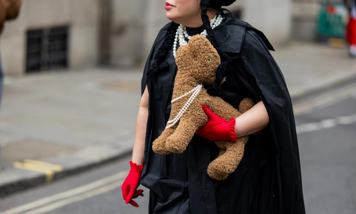 <span>A guest carries a stuffed teddy bag from Simone Rocha during London fashion week in September 2024.</span><span>Photograph: Christian Vierig/Getty Images</span>