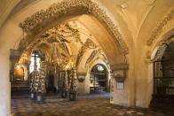 <p>A small, Gothic church in Sedlec, near Kutna Hora in the Czech Republic, houses the bones of some 40,000 people who, in life, wanted to ensure quick ascension to the afterlife. A local woodcarver was hired to transform the bones into chandeliers, buntings, candleholders, and even a coat of arms to decorate the <a rel="nofollow noopener" href="http://www.travelandleisure.com/slideshows/worlds-creepiest-attractions/9" target="_blank" data-ylk="slk:Sedlec Ossuary;elm:context_link;itc:0;sec:content-canvas" class="link ">Sedlec Ossuary</a> in macabre artwork. In an almost celebratory fashion, garlands of skulls crisscross the ceiling. Perhaps surprisingly, this isn’t the world’s only bone church. Visit the Chapel of Bones (Capela de Ossos) in Evora, Portugal, which contains the bones of 5,000 monks and features two bodies, one of a child, dangling from the ceiling.</p>