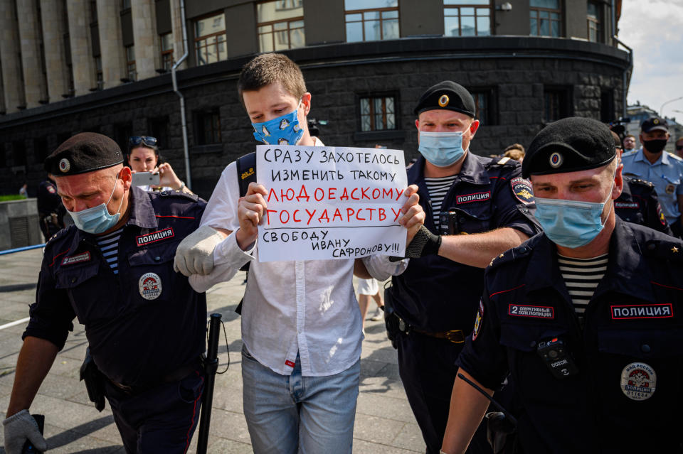 Police officers detain a supporter of Ivan Safronov, a former journalist and aide to the head of Russia's space agency Roscosmos, outside the headquarters of Russia's Federal Security Services (FSB) in central Moscow, July 7, 2020. / Credit: DIMITAR DILKOFF/AFP/Getty