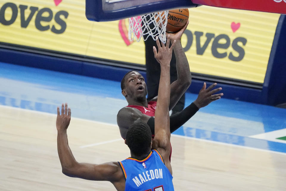 Miami Heat guard Kendrick Nunn, rear, shoots in front of Oklahoma City Thunder guard Theo Maledon, front in the second half of an NBA basketball game Monday, Feb. 22, 2021, in Oklahoma City. (AP Photo/Sue Ogrocki)