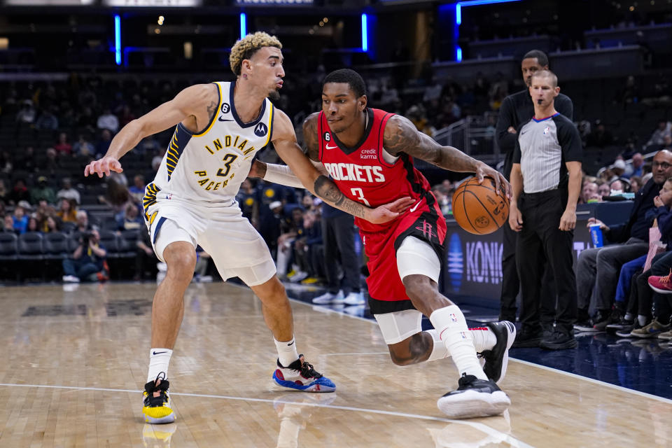 Houston Rockets guard Kevin Porter Jr. (3) drives on Indiana Pacers guard Chris Duarte (3) during the first half of an NBA preseason basketball game in Indianapolis, Friday, Oct. 14, 2022. (AP Photo/Michael Conroy)