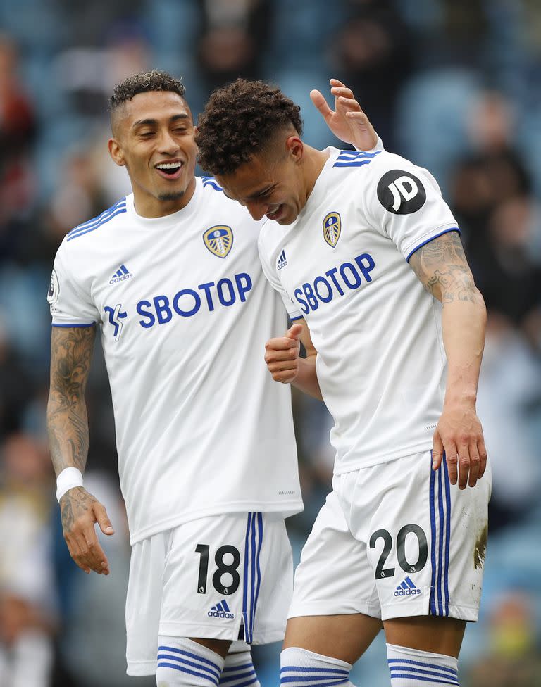 Leeds United's Rodrigo, right, celebrates scoring the opening goal during the English Premier League soccer match between Leeds United and West Brom at Elland Road in Leeds, England, Sunday May 23, 2021. (Lynne Cameron/Pool via AP)