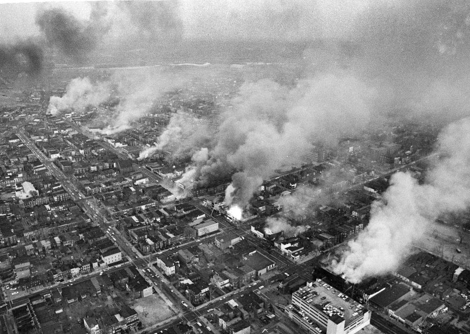 FILE - In this April 5, 1968 file photo, buildings burn along H Street in the northeast section of Washington, set afire during a day of demonstrations and rioting in reaction to the assassination of Dr. Martin Luther King Jr. (AP Photo/Charles Gorry, File)