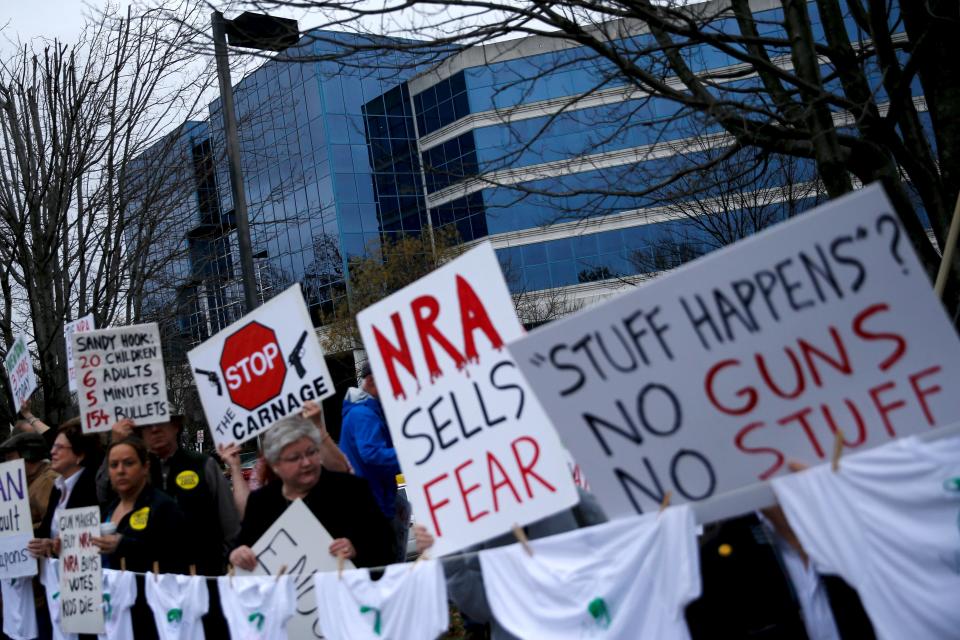 Activists hold a protest and vigil against gun violence on the third anniversary of the Sandy Hook mass shooting, outside the National Rifle Association (NRA) headquarters in Fairfax, Virginia December 14, 2015. REUTERS/Jonathan Ernst