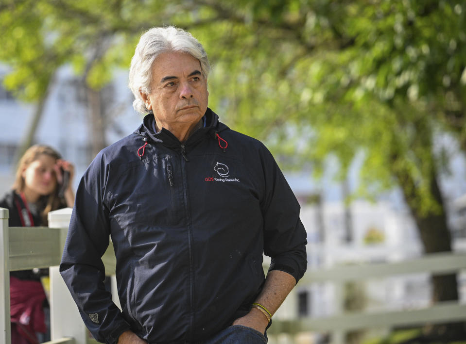 Trainer Gustavo Delgado watches as Kentucky Derby winner Mage heads to the Pimlico track for a workout Tuesday morning, May 16, 2023, in Baltimore, in preparation for Saturday's Preakness Stakes horse race. (Jerry Jackson/The Baltimore Sun via AP)