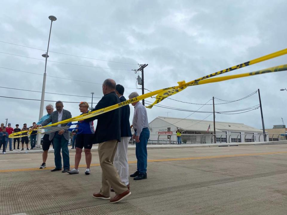 Fort Worth Mayor Betsy Price cuts caution tape that was stretched across the White Settlement Road bridge when it opened in 2021.. Emerson Clarridge