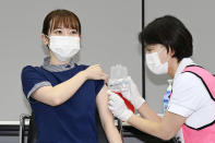 A medical worker receives a booster shot of the Pfizer COVID-19 vaccine Wednesday, Dec. 1, 2021, at Fujita Health University Hospital, in Toyoake city, central Japan. Japan on Wednesday started offering booster shots of coronavirus vaccine, starting with healthcare workers, to further bolster immunity in the country amid growing concerns about a new variant of the virus. (Mizuki Ikari/Kyodo News via AP)