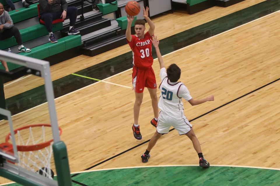 Chaparral's Trey Thomason (30) lines up for a successful 3-point shot over the outstretched arms of Shiprock's Nevaughn Begay during the first quarter of a first round game of the Marv Sanders Memorial Invitational Tournament, Thursday, Dec. 15, 2022 at Farmington High School's Scorpion Arena.