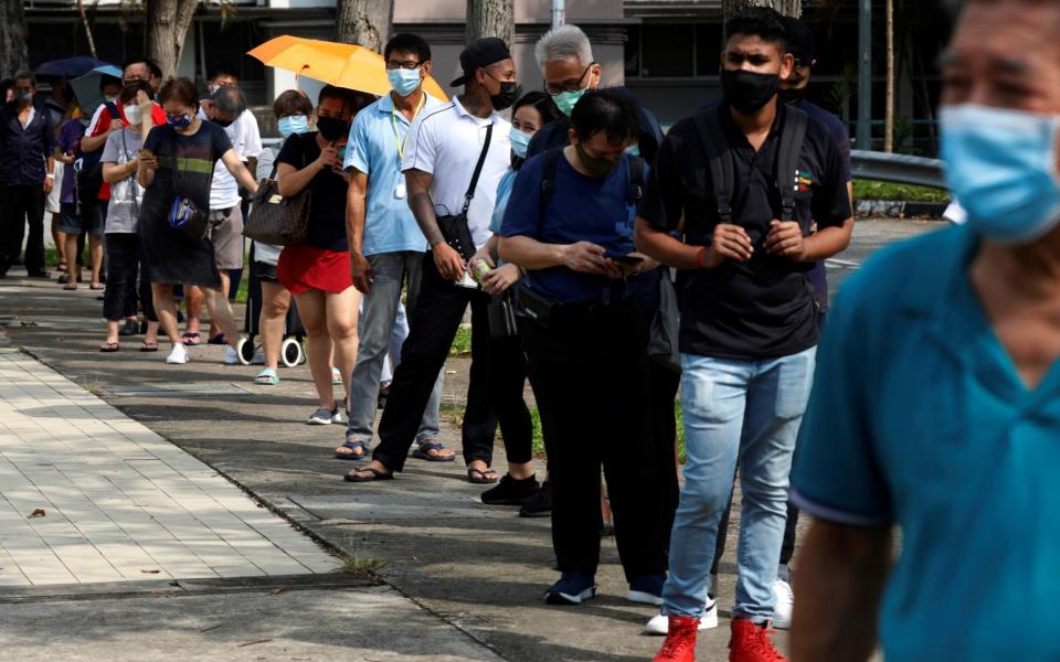 People queue for a coronavirus test in Singapore - Edgar Su/Reuters