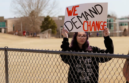 A Columbine High School student holds a sign outside the school during a National School Walkout to honor the 17 students and staff members killed at Marjory Stoneman Douglas High School in Parkland, Florida, in Littleton, Colorado, U.S. March 14, 2018. REUTERS/Rick Wilking