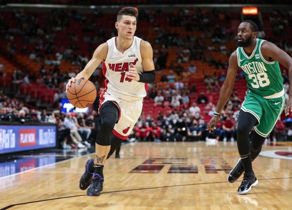 Miami Heat guard Tyler Herro (14) drives the ball in the second quarter against Boston Celtics Theo Pinson (38) at the FTX Arena in Miami on Friday, October 15, 2021.