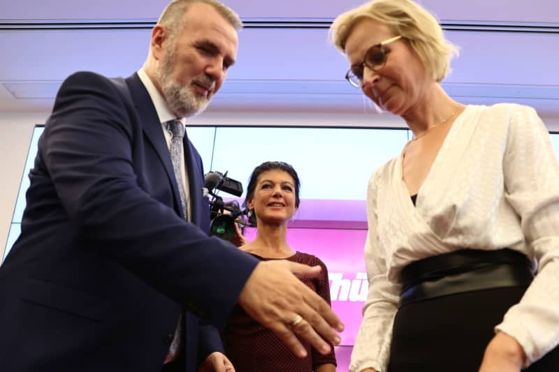 Katja Wolf (R), state chairwoman and lead candidate of the Sahra Wagenknecht Alliance (BSW) in Thuringia and Steffen Schuetz, state chairman and lead candidate of the BSW in Thuringia, react with party chairwoman Sahra Wagenknecht after the first forecast results for the state election in Thuringia, at the election party of the BSW. Christoph Soeder/dpa