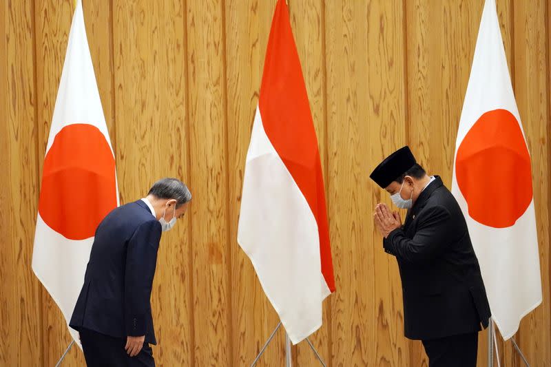 Indonesia's Foreign Minister Retno Marsudi and Defense Minister Prabowo Subianto attend a courtesy call with Japan's Prime Minister Yoshihide Suga in Tokyo