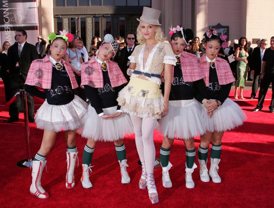 Gwen Stefani poses with the Harajuku Girls as they arrive to the 32nd Annual "American Music Awards" on November 14, 2004 in Los Angeles, California.