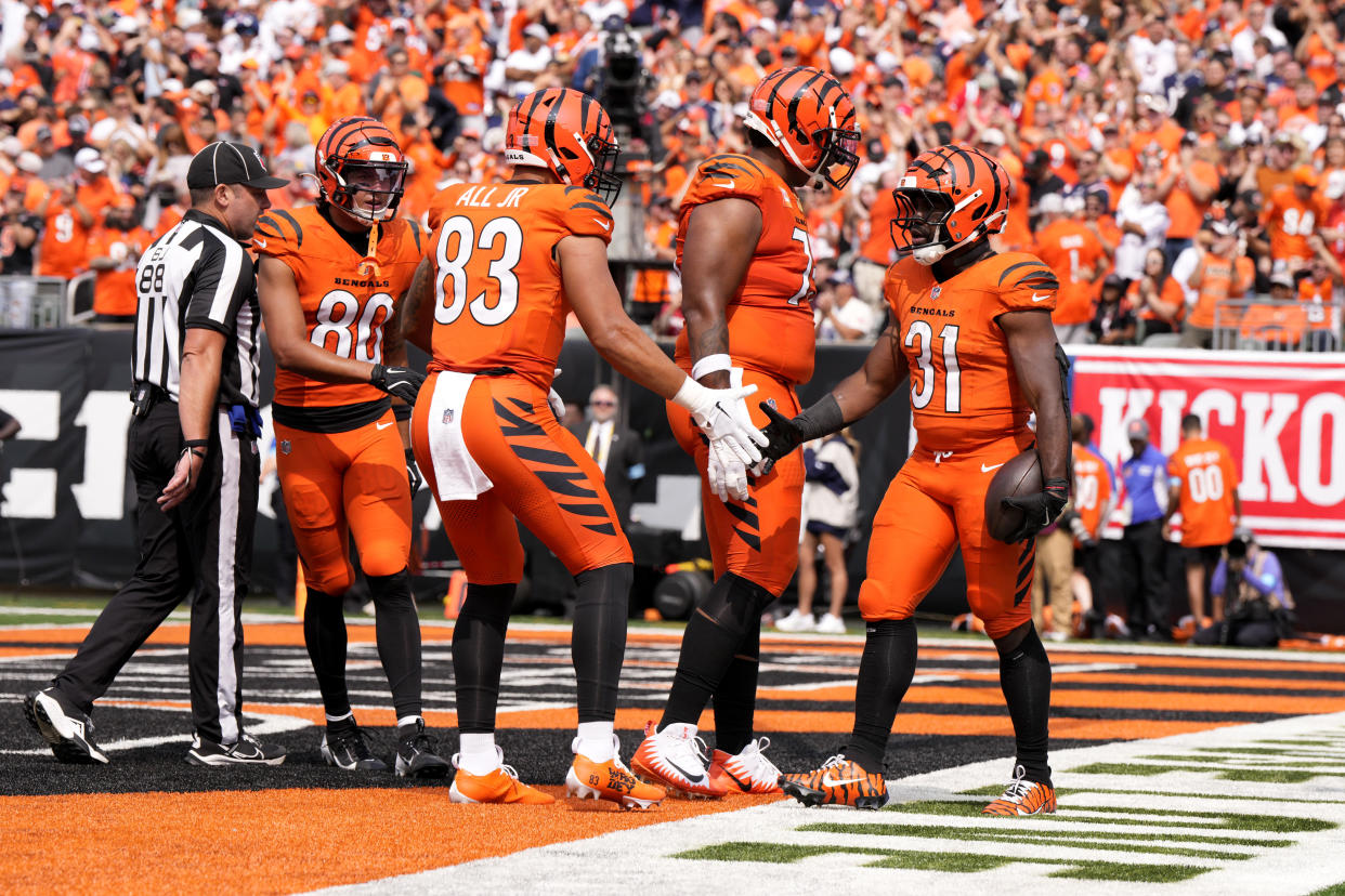 Cincinnati Bengals running back Zack Moss (31) celebrates with teammates after scoring on a 5-yard touchdown run during the second half of an NFL football game against the New England Patriots, Sunday, Sept. 8, 2024, in Cincinnati. (AP Photo/Jeff Dean)