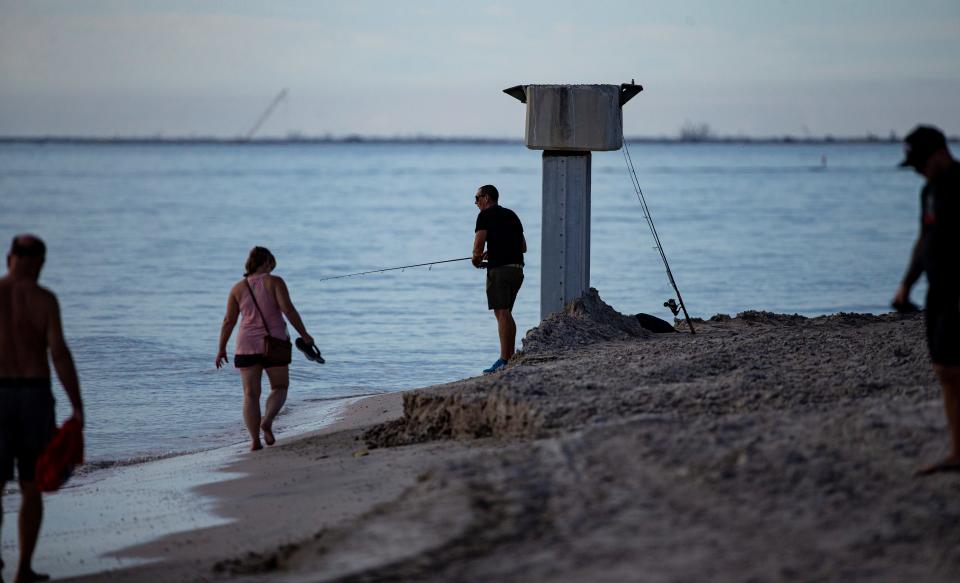 Visitors hang out on Fort Myers Beach  on Wednesday, Nov. 23, 2022.  The area was slammed by Hurricane Ian almost two months ago.  