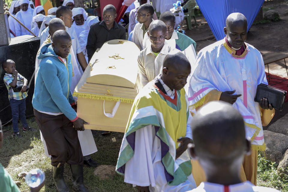 Friends and family carry the casket of Rose Bella Awuor, 31 years, after a funeral service at her home in Awendo, Migori County, Kenya Thursday, April. 11, 2024. Awuor fell ill in December and lost her five-month pregnancy before succumbing to malaria. It was the latest of five deaths in this family attributed to malaria. The disease is endemic to Kenya and is preventable and curable, but poverty makes it deadly for those who can't afford treatment. (AP Photo/Brian Ongoro)