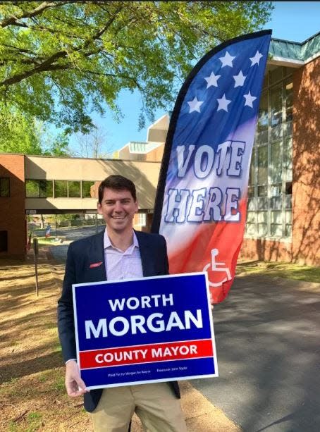 Memphis City Councilman Worth Morgan holds a campaign sign as he runs for Shelby County Mayor in this undated photo.