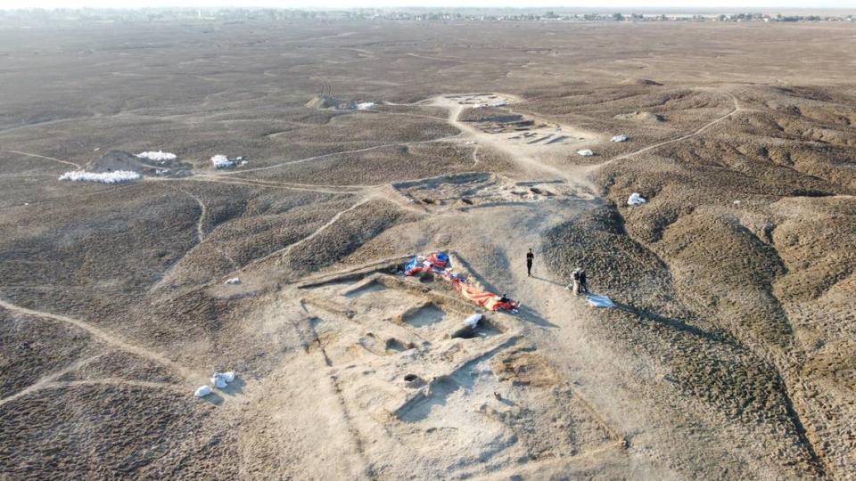 An aerial photo showing the excavation area with the tavern in the foreground.