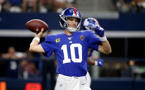 New York Giants quarterback Eli Manning (10) throws a pass in the second half of a NFL football game against the Dallas Cowboys in Arlington, Texas - Credit: AP