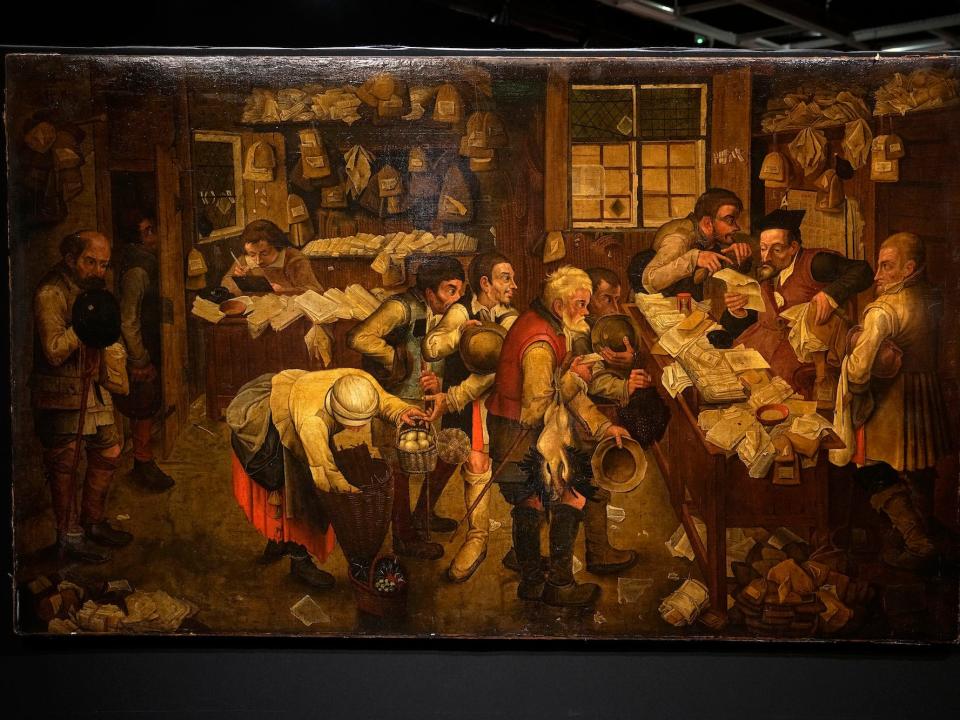 A photo of the oil painting "The Village Lawyer" by Pieter Brueghel the Younger, prior to its auction in Paris on March 27, 2023.  It shows a bustling lawyer's office in the 17th century.