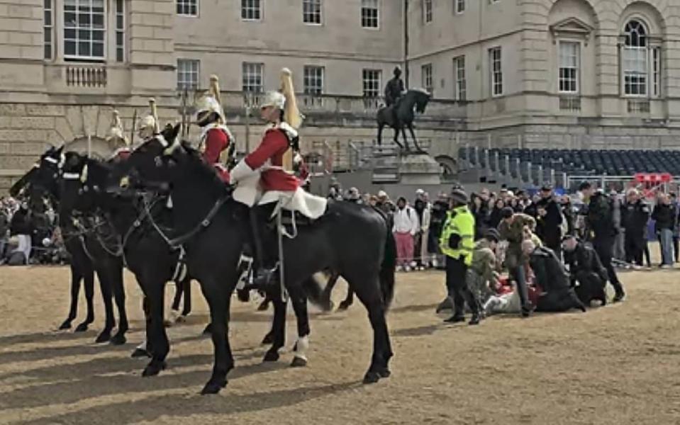 Medics tend to a trooper thrown off his horse at Horse Guards Parade on Wednesday